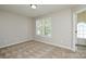 Bedroom featuring a window, carpet, and neutral walls at 7711 Brisbane Ct, Charlotte, NC 28215