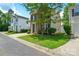 View of a well-maintained two-story home with an attached garage and green lawn at 7711 Brisbane Ct, Charlotte, NC 28215