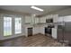 Bright kitchen with stainless steel appliances, white cabinets, and ample counter space at 7711 Brisbane Ct, Charlotte, NC 28215