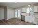 Modern kitchen with white cabinets, stainless steel appliances and hardwood floors at 7711 Brisbane Ct, Charlotte, NC 28215
