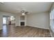 Spacious living room featuring a fireplace and neutral tones, with an open view to kitchen at 7711 Brisbane Ct, Charlotte, NC 28215