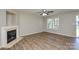 Bright living room features a fireplace, ceiling fan and lots of natural light at 7711 Brisbane Ct, Charlotte, NC 28215