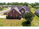 Aerial view of a brick home with a well-maintained lawn and mature landscaping at 786 Sw Treva Anne Sw Dr, Concord, NC 28027