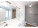 Bright bathroom with a double sink vanity, large mirror, and tile floor at 786 Sw Treva Anne Sw Dr, Concord, NC 28027