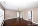 This bedroom has dark wood floors, beige walls, and natural lighting at 786 Sw Treva Anne Sw Dr, Concord, NC 28027