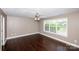 Minimalist bedroom with hardwood floors, natural light, and a ceiling fan at 786 Sw Treva Anne Sw Dr, Concord, NC 28027