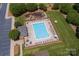 Overhead view of a community pool with lounge chairs and nearby playground at 786 Sw Treva Anne Sw Dr, Concord, NC 28027