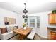 Dining area features a wooden table and bench with a bay window view at 786 Sw Treva Anne Sw Dr, Concord, NC 28027