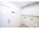 Clean laundry room with cabinet storage and convenient hook for keys at 786 Sw Treva Anne Sw Dr, Concord, NC 28027