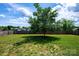 Expansive backyard with a sprawling lawn, mature tree, and a wood fence, creating a private and picturesque outdoor setting at 786 Treva Anne Sw Dr, Concord, NC 28027