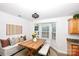 Cozy dining area with built-in bench, wooden table, and bay window at 786 Treva Anne Sw Dr, Concord, NC 28027