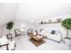 A living room with lots of sunlight, a wooden coffee table, hardwood floors, a ceiling fan, and a white couch at 786 Treva Anne Sw Dr, Concord, NC 28027