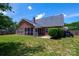 Brick home boasts a screened porch and well-maintained yard, offering a blend of comfort and outdoor enjoyment at 786 Treva Anne Sw Dr, Concord, NC 28027