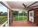 View from enclosed porch looks out onto a well-maintained backyard, offering a seamless connection to outdoor living at 786 Treva Anne Sw Dr, Concord, NC 28027