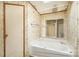 A full-sized tub sits under an updated mirror in this bathroom featuring a ceiling fan at 811 Acclaim Dr, York, SC 29745