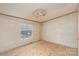This unfinished bedroom features a ceiling fan and a window providing ample natural light at 811 Acclaim Dr, York, SC 29745