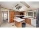 Cozy kitchen with wood cabinets, a central island, and black appliances, ready for your culinary touch at 811 Acclaim Dr, York, SC 29745
