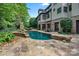 Expansive backyard with stone patio, inground pool, and ample seating areas perfect for entertaining at 8534 Highgrove St, Charlotte, NC 28277