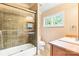 Tiled bathroom with a walk-in shower, modern fixtures, and natural light at 8534 Highgrove St, Charlotte, NC 28277