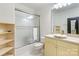 Well-lit bathroom featuring a tub/shower combo with glass doors and a single sink vanity at 8534 Highgrove St, Charlotte, NC 28277