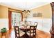 Formal dining room with hardwood floors, elegant chandelier, and wainscoting at 8534 Highgrove St, Charlotte, NC 28277