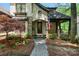 Charming home featuring a stone and stucco facade, arched entryway, and a beautifully landscaped front yard at 8534 Highgrove St, Charlotte, NC 28277