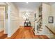 An elegant foyer with hardwood floors, wainscoting, staircase, and stylish decor that create a welcoming entrance at 8534 Highgrove St, Charlotte, NC 28277