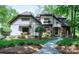 Charming two-story home with manicured lawn, lush landscaping, and a stone walkway leading to the front door at 8534 Highgrove St, Charlotte, NC 28277