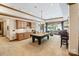 Entertainment space with billiards table, wet bar, and access to outdoor seating area at 8534 Highgrove St, Charlotte, NC 28277