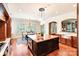 Bright kitchen with large island, hardwood floors, and an adjacent dining area at 8534 Highgrove St, Charlotte, NC 28277