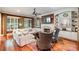 Cozy living room featuring a fireplace, built-in shelving, and large windows for lots of natural light at 8534 Highgrove St, Charlotte, NC 28277