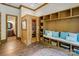 Spacious mudroom features a sauna, built-in storage, bench seating, and beautiful wood flooring at 8534 Highgrove St, Charlotte, NC 28277