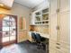 Comfortable home office featuring built-in desk, storage cabinets, and arched doorway entrance at 8534 Highgrove St, Charlotte, NC 28277