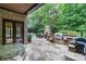 Outdoor space with stone patio, outdoor kitchen, stone fireplace, and manicured green space at 8534 Highgrove St, Charlotte, NC 28277