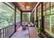 Relaxing screened porch with comfortable seating and an outdoor ceiling fan offering an ideal spot for relaxation at 8534 Highgrove St, Charlotte, NC 28277