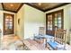 Inviting porch with stone flooring, ceiling, rocking chairs, and wood accents at 8534 Highgrove St, Charlotte, NC 28277