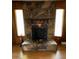 Close-up of the impressive stone fireplace with a rustic mantel and hearth at 947 Ravendale Dr, Charlotte, NC 28216