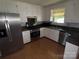 Modern kitchen boasts stainless steel appliances, granite countertops, and ample cabinet space at 947 Ravendale Dr, Charlotte, NC 28216