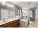 Bathroom featuring a large vanity, soaking tub, and serene lighting at 9533 Silverdale Ln, Charlotte, NC 28269