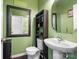 Powder room featuring a toilet, vanity, mirror and a cabinet with shelving at 9533 Silverdale Ln, Charlotte, NC 28269