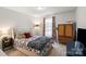 Comfortable bedroom with patterned bedding, warm lighting, and neutral tones at 9533 Silverdale Ln, Charlotte, NC 28269