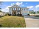 Charming two-story home with a brick facade, landscaped yard, and an attached two-car garage at 9533 Silverdale Ln, Charlotte, NC 28269