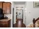 Hallway with hardwood floors, stairs, and a view of the front entrance with wreath decoration at 9533 Silverdale Ln, Charlotte, NC 28269