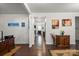Hallway with hardwood floors, decorative accents, and doorways leading to other rooms at 9533 Silverdale Ln, Charlotte, NC 28269