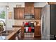 Stylish kitchen featuring stainless steel appliances, granite counters, a tile backsplash, and ample cabinet space at 9533 Silverdale Ln, Charlotte, NC 28269