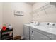 Convenient laundry room equipped with a washer, dryer, and shelf at 9533 Silverdale Ln, Charlotte, NC 28269