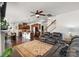 Spacious living room featuring a leather couch, dark hardwood floors, and an eat-in kitchen at 9533 Silverdale Ln, Charlotte, NC 28269