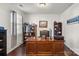 Well-appointed office space with a large wooden desk, built-in shelving, and hardwood floors at 9533 Silverdale Ln, Charlotte, NC 28269