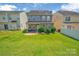 View of a well-maintained backyard with a lush green lawn and a charming patio area at 9614 Turning Wheel Dr, Charlotte, NC 28214