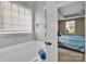 Bathroom showcasing a large tub, window for natural light, and neutral wall color at 9614 Turning Wheel Dr, Charlotte, NC 28214